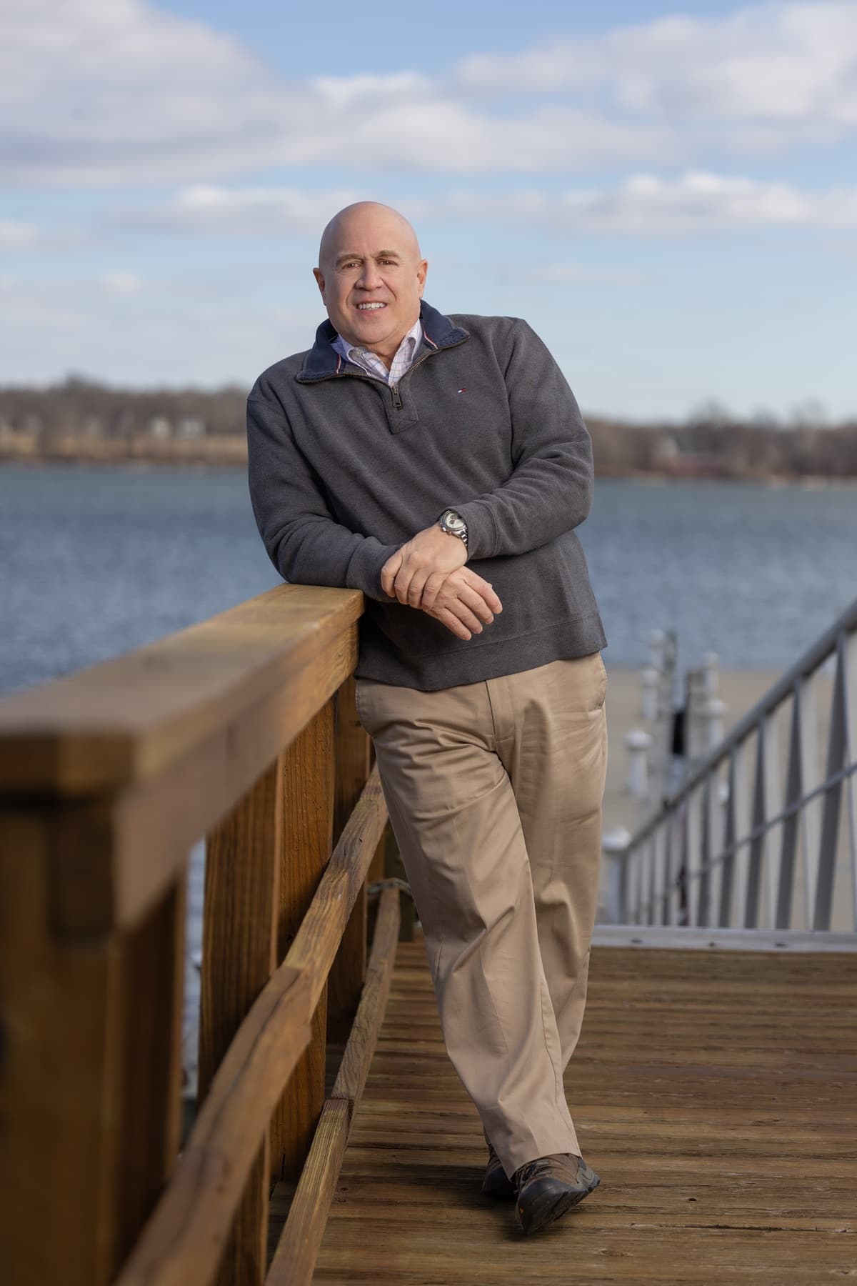 Paul standing on a waterfront boardwalk
