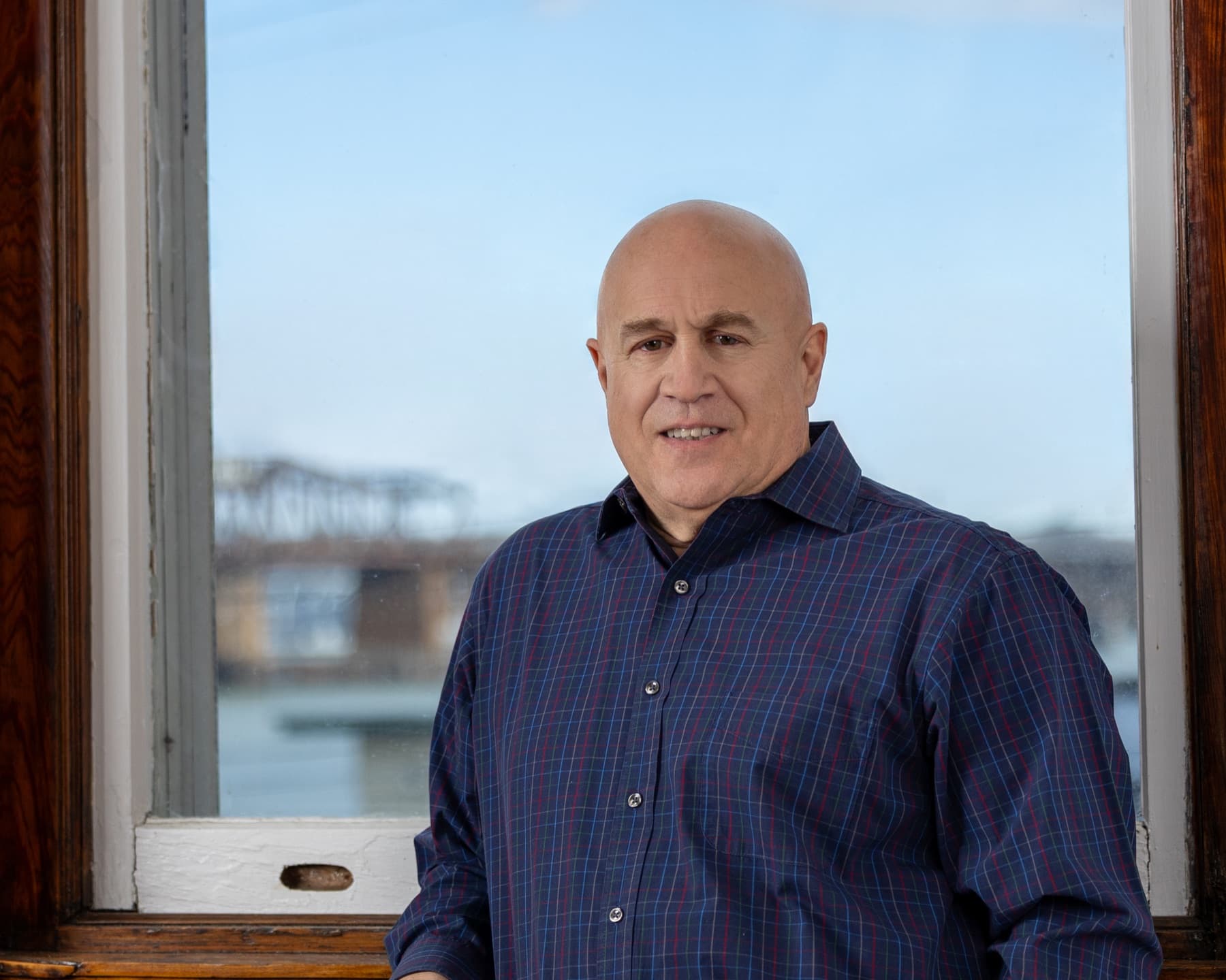 Paul Iannacone by a waterfront window
